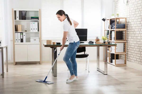 Giovane donna pulizia pavimento — Foto Stock
