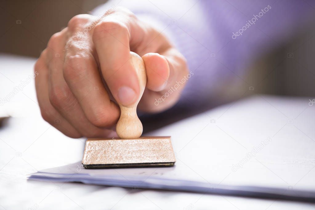 Person Stamping On Document