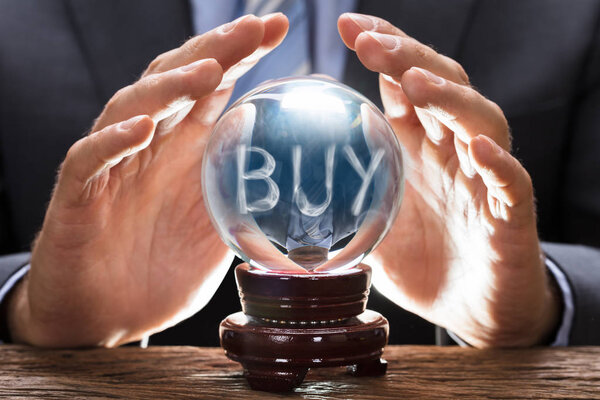 Businessman Covering Crystal Ball 