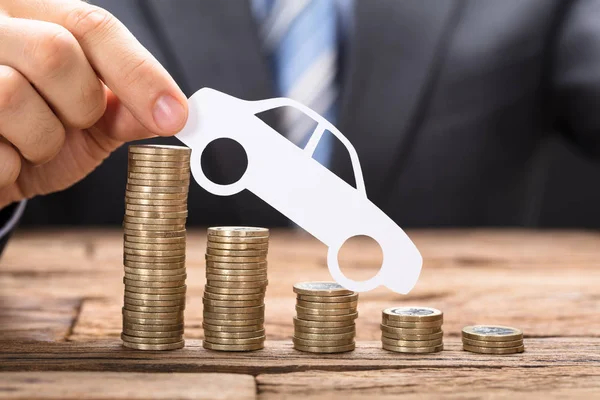 Businessman holding paper car — Stock Photo, Image