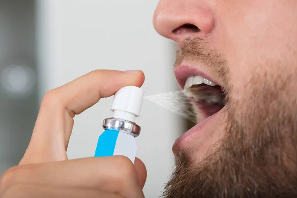 Man Spraying Breath Freshener — Stock Photo, Image