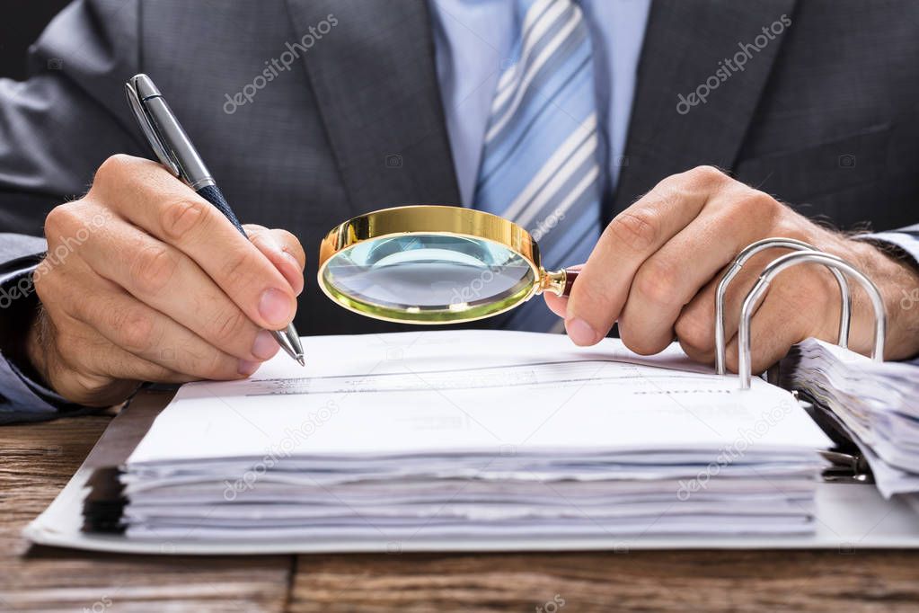 Businessman Examining Invoice 