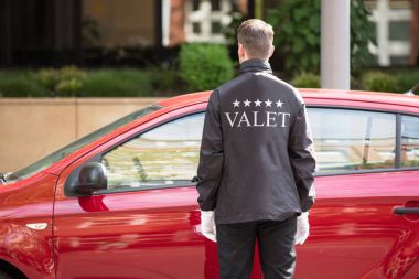 Young Male Valet Opening Car  clipart