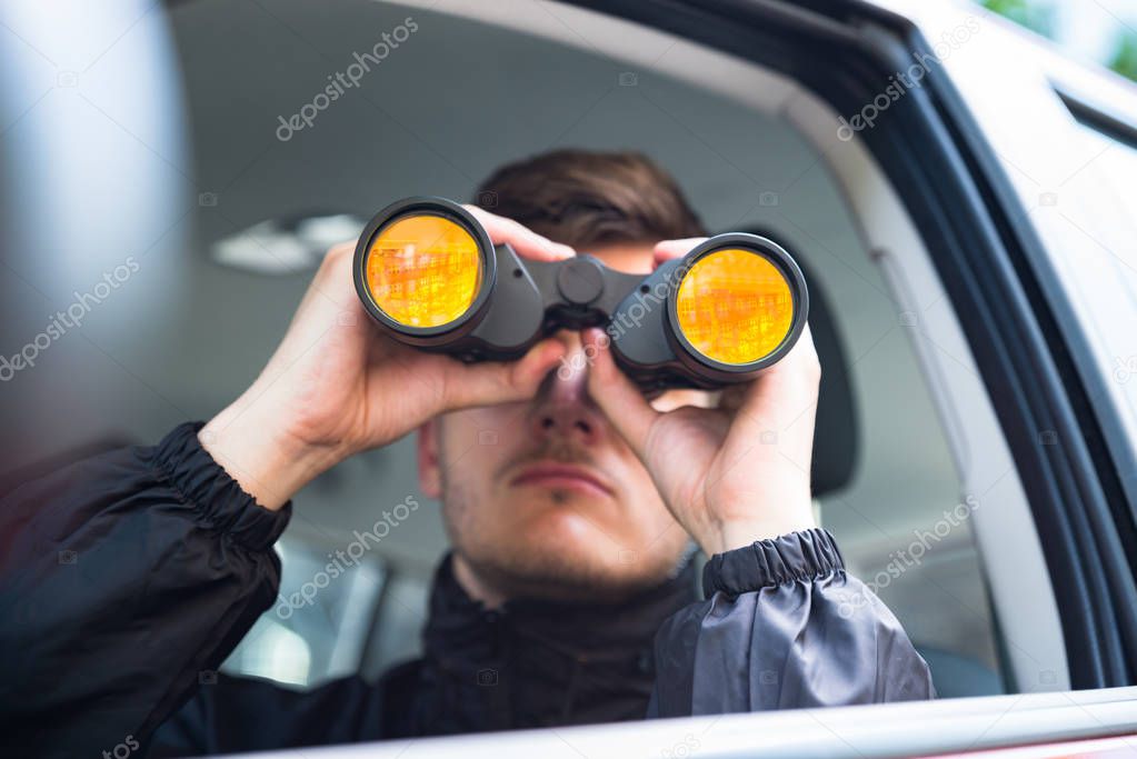 Man Looking Through Binocular