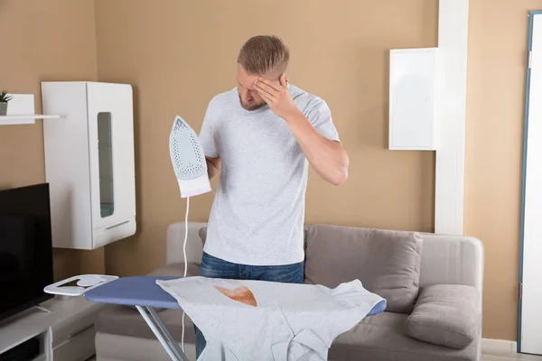 Sad Young Man Holding Iron — Stock Photo, Image