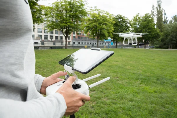 Man Operating Quadrocopter