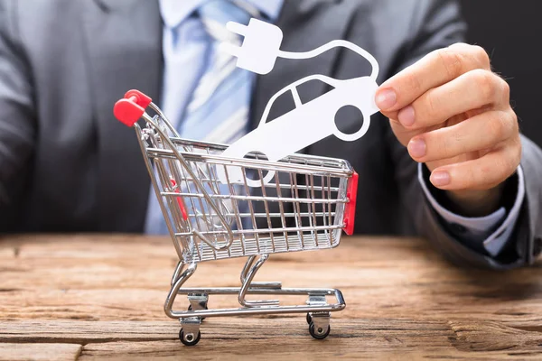 Businessman Holding Paper Car