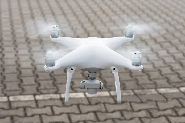 Drone flying over cobbled street