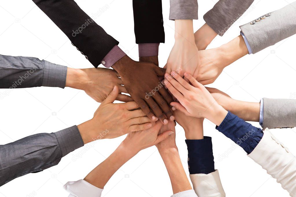 Elevated View Of Multi Ethnic Business People Stacking Hands Against White Background