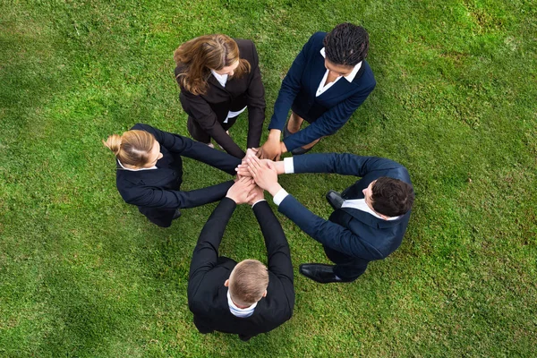 Elevated View Businesspeople Standing Green Grass Stacking Hands — Stock Photo, Image