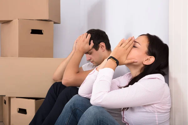 Casal cansado perto de caixas — Fotografia de Stock