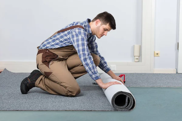 Handyman Rolling Carpet — Stock Photo, Image