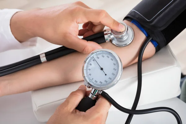 Doctor Checking Blood Pressure Stock Photo