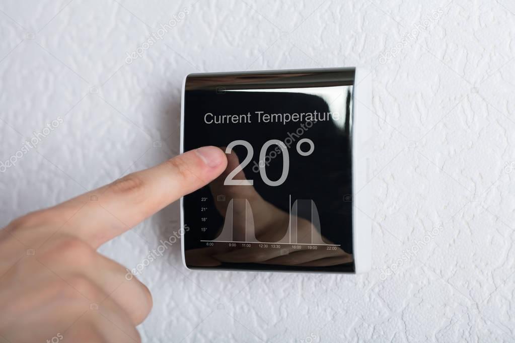 Person Touching Thermostat 