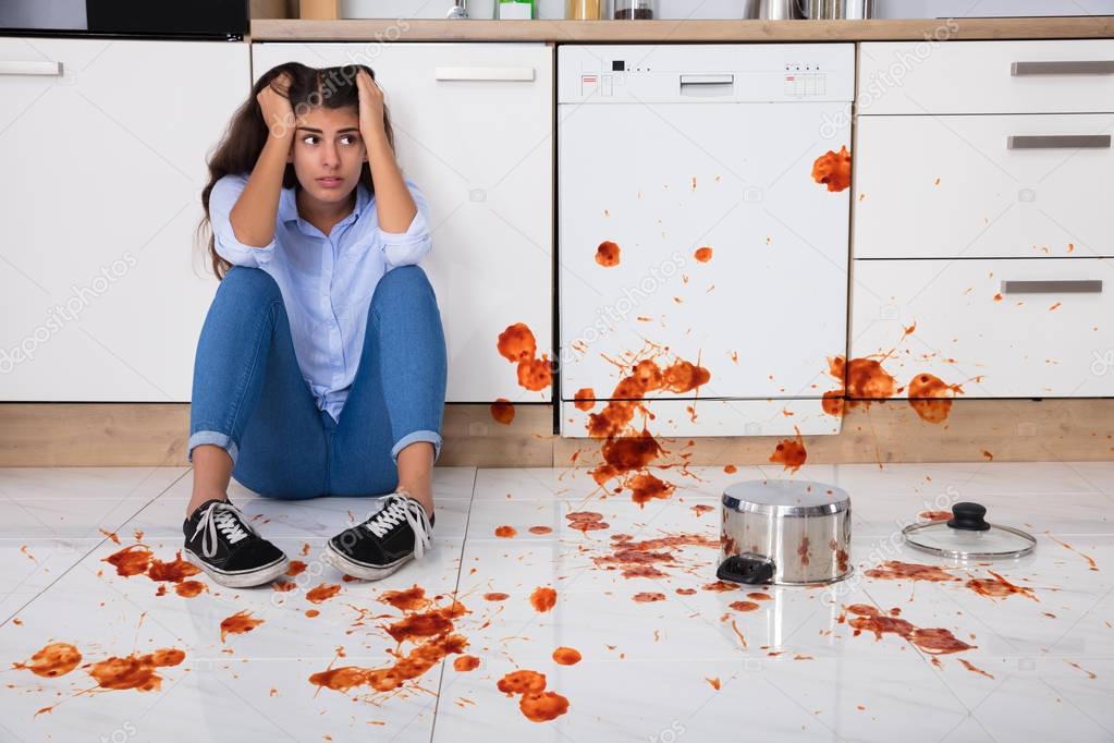 Woman Sitting On Kitchen Floor 