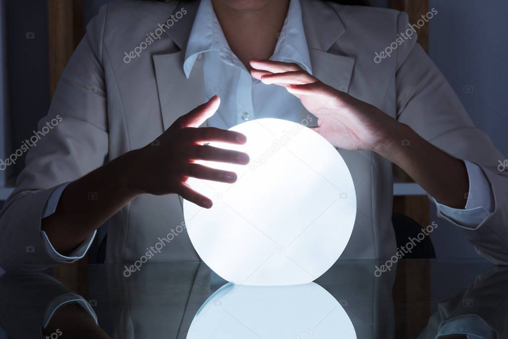 Businesswoman Hands On Crystal Ball