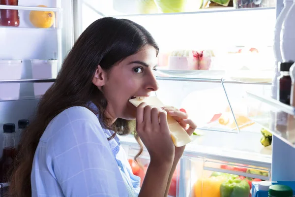 Woman Eating Slice Of Cheese — Stock Photo, Image