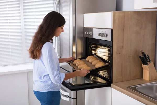 Woman Taking Out Tray — Stock Photo, Image