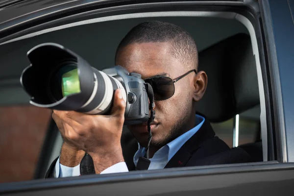 Detektyw siedzi wewnątrz samochodu fotografowania — Zdjęcie stockowe