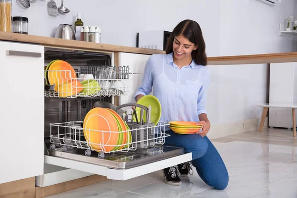 Woman Arranging Plates In Dishwasher — Stock Photo, Image