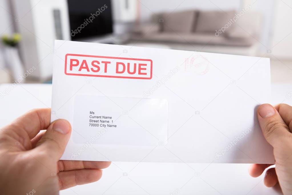 Person Holding Past Due Bill 