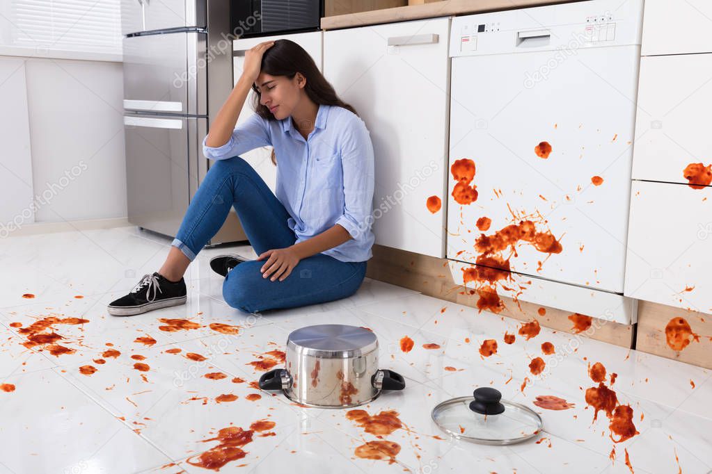 Woman Sitting On Kitchen Floor 