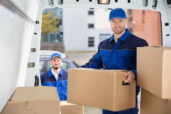 Movers Unloading Cardboard Boxes — Stock Photo, Image