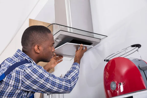 African Male Fixing Kitchen Extractor Filter — Stock Photo, Image