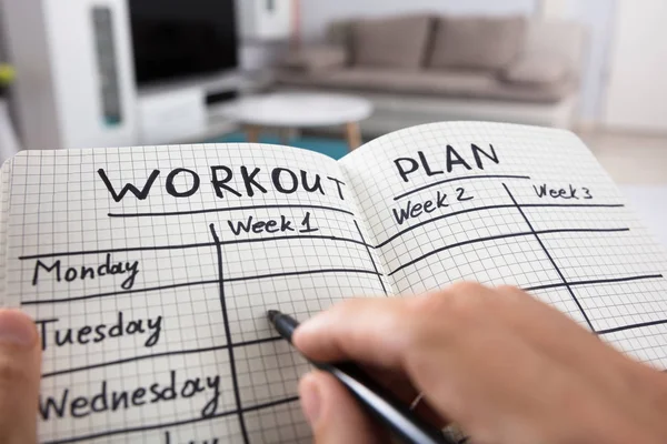 Person Writing Workout Plan — Stock Photo, Image