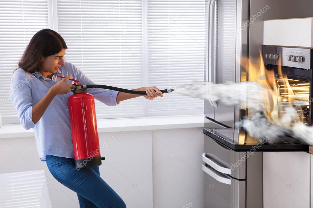 Woman Using Fire Extinguisher 
