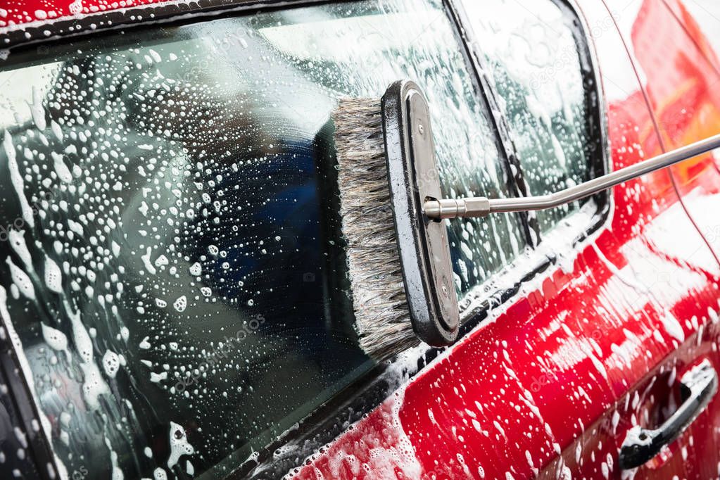 Person's Hand Washing Car