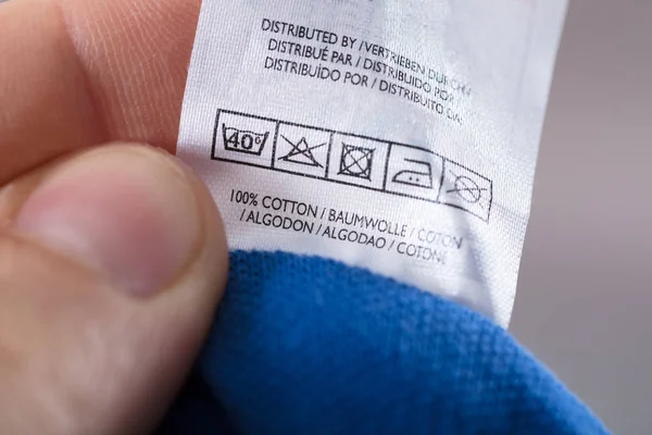 Person Reading Clothing Label — Stock Photo, Image