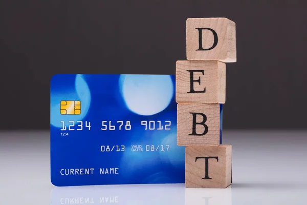 Palabra de deuda en bloque de madera — Foto de Stock