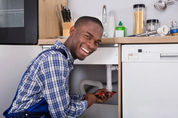 Plumber Fixing Sink Pipe