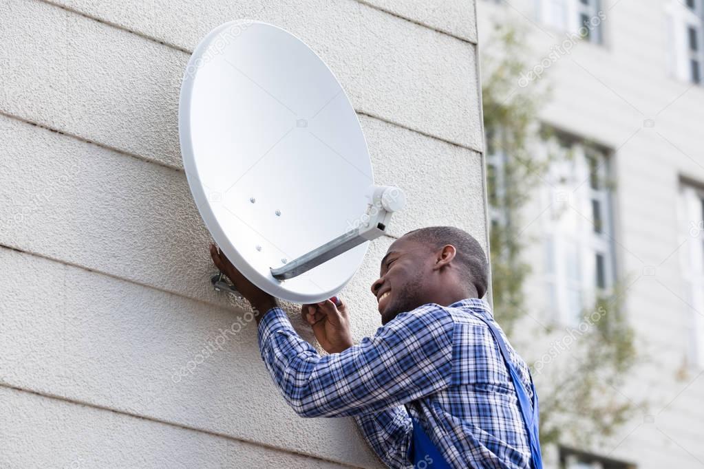 Man Fitting TV Satellite Dish