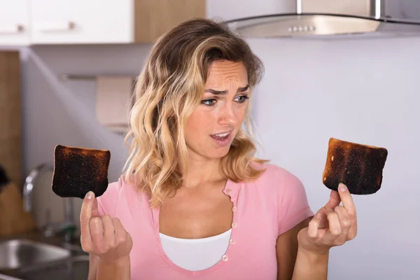 Woman Holding Burnt Toasts