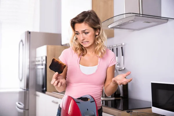 Woman Removing Toast — Stock Photo, Image