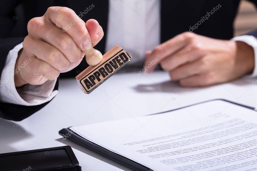 Person Hands Using Stamper 