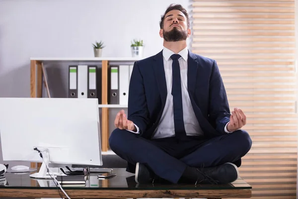 Businessman Doing Meditation In Office — Stock Photo, Image