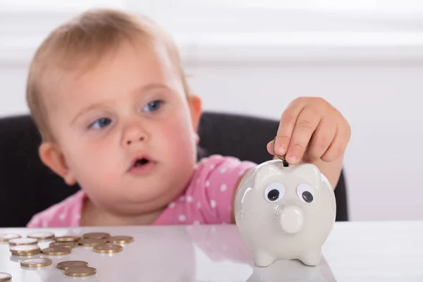 Baby Inserting Coin In Piggybank — Stock Photo, Image