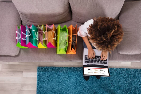 Happy Young Woman Using Laptop Multi Colored Shopping Bags Carpet — стоковое фото