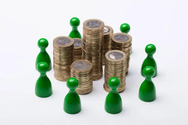 Close Coin Stack Surrounded Green Figures White Background — Stock Photo, Image