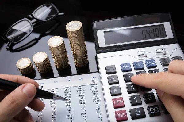 Close Businessperson Hand Calculating Financial Data Stacked Coins Desk — Stock Photo, Image