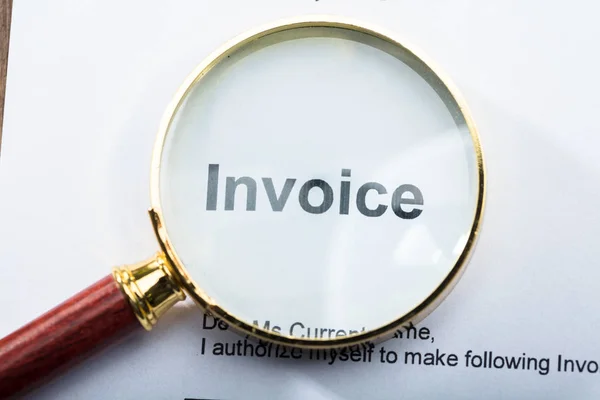Close Invoice Text Seen Magnifying Glass — Stock Photo, Image