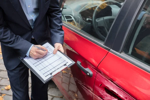 Agente Assicurativo Scrivere Sugli Appunti Durante Esame Auto Dopo Incidente — Foto Stock