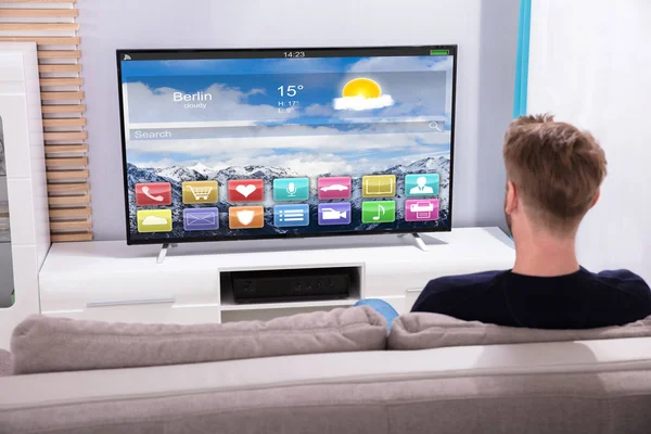 Rear View Young Man Watching Television Showing Colorful Application — Stock Photo, Image