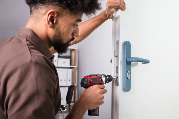 Close Young Male Carpenter Installing Door Lock Wireless Screwdriver — Stock Photo, Image