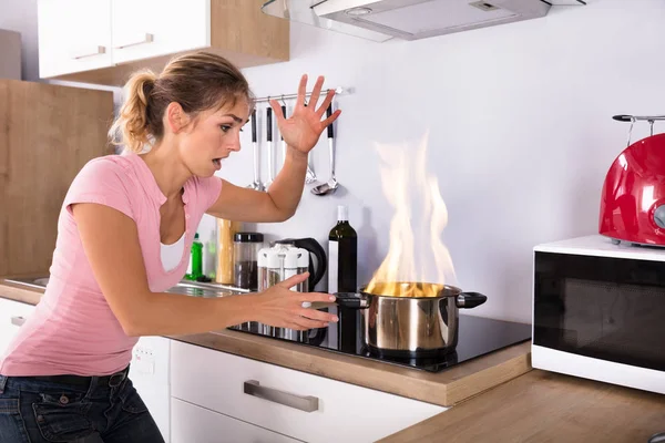 Shocked Young Woman Looking Cooking Pot Fire Modern Gas Kitchen — Stock Photo, Image