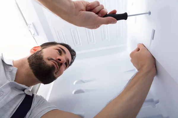キッチンに冷蔵庫を固定男性電気技師のクローズ アップ — ストック写真