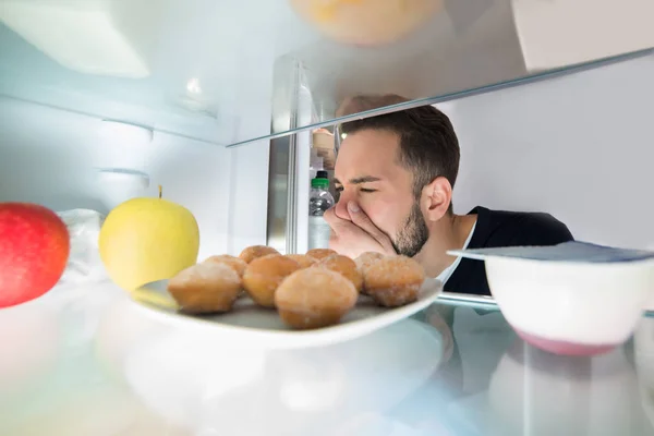 Genç Bir Adamın Burnunu Yanında Faul Yiyecek Buzdolabında Tutarak Yakın — Stok fotoğraf